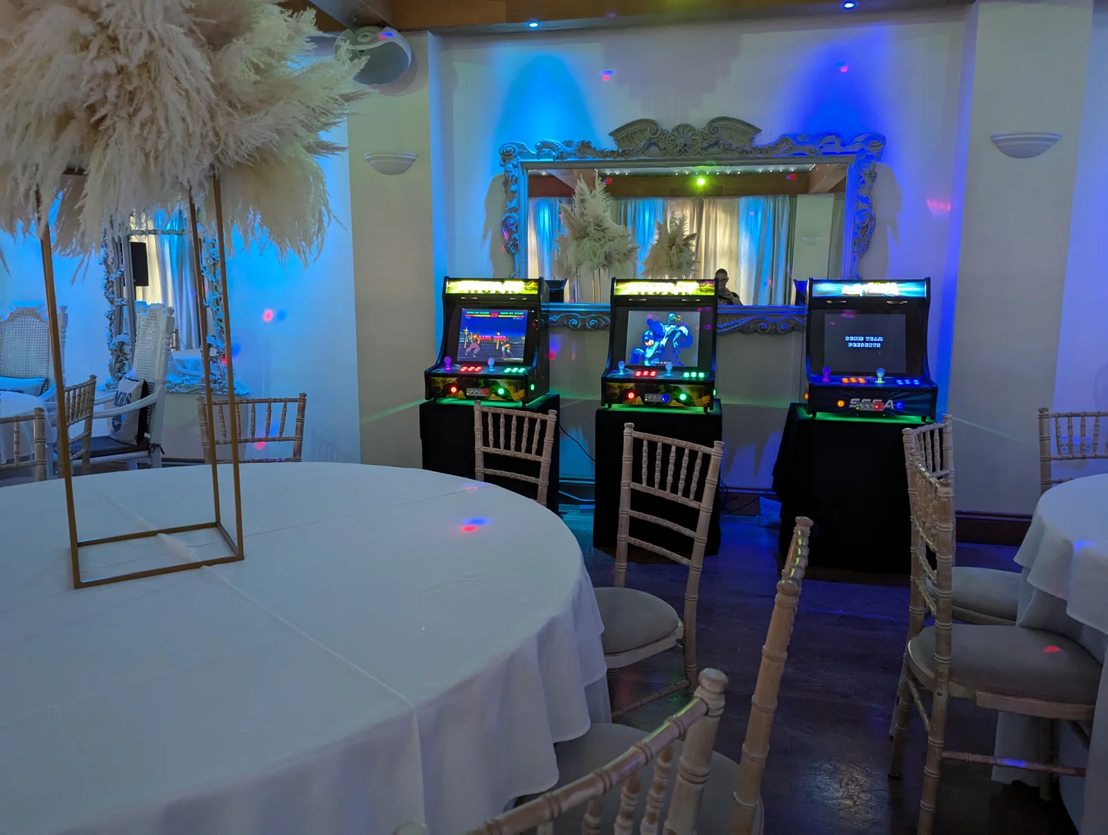 Arcade machines set up beside decorated event tables
