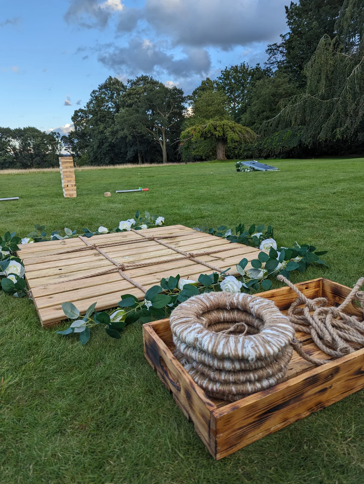 Rustic noughts and crosses, wooden blocks and beanbag boards on a lawn