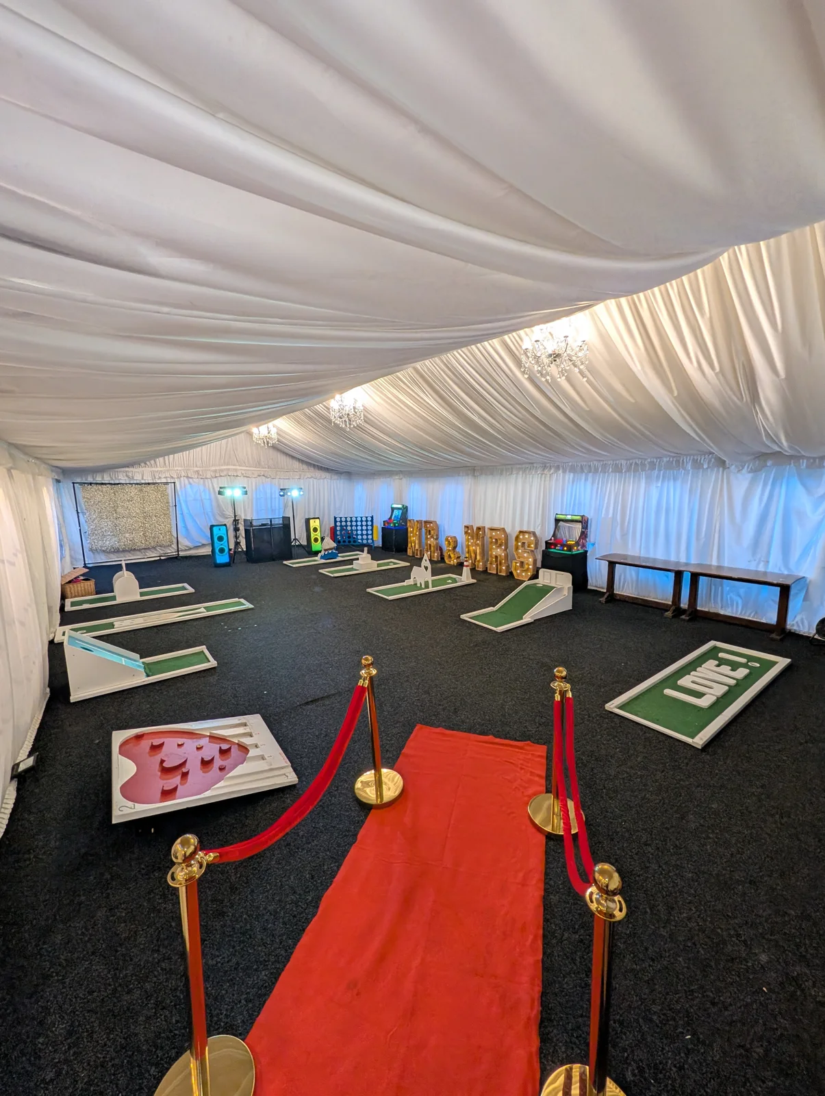 Portable mini golf holes arranged in a marquee for an event