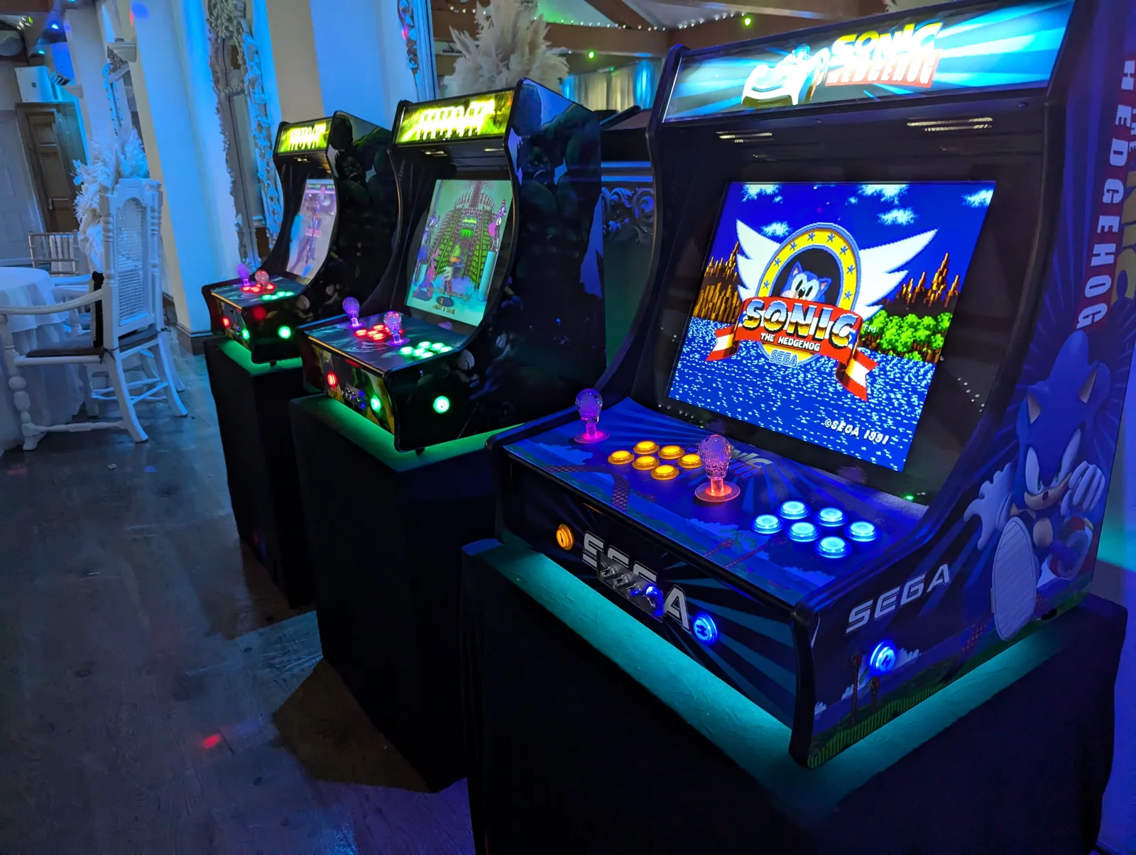 Colourful retro arcade cabinets set up for an event