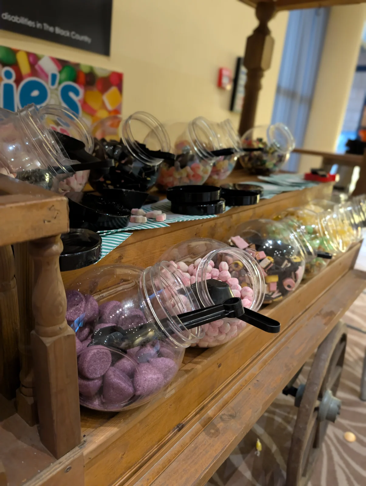 Close-up of sweet jars and scoops on the cart
