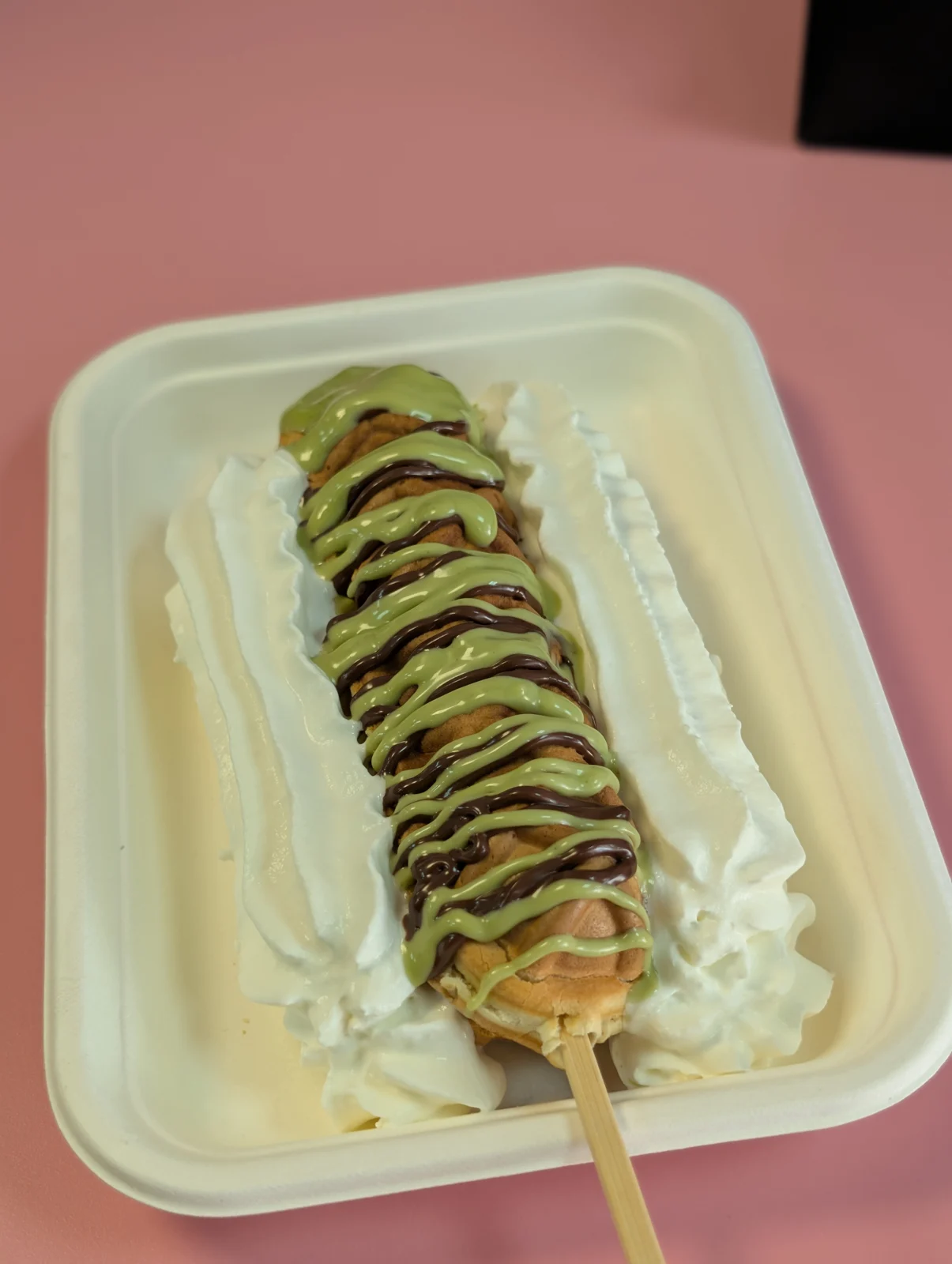 Waffle with drizzled toppings and cream